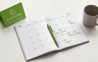 A diary open to May and June with dates circled in green and a FluClinic2You 2026/27 flu programme tent card, representing how HR managers should book employee flu vaccinations early before the autumn season